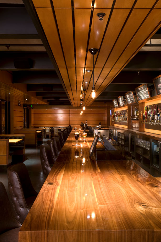 A 50 foot long bar, which runs the entire length of the room is an essential element to the design of Father’s Office.