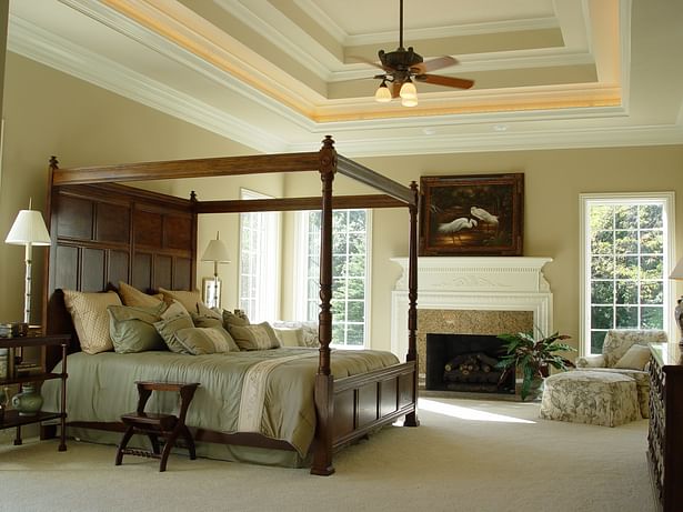 Multi-level tray ceiling adds visual height and character to this master bedroom.