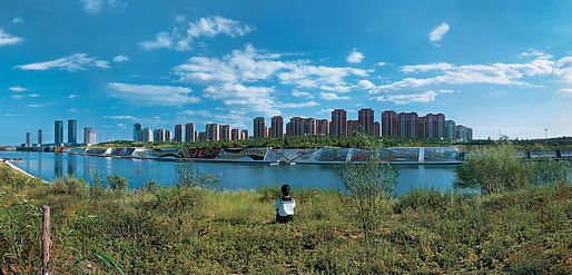Two schoolgirls gazing out to Kangbashi New Area, formerly farmland and now the showpiece district of Ordos City, in China. Weng Fen