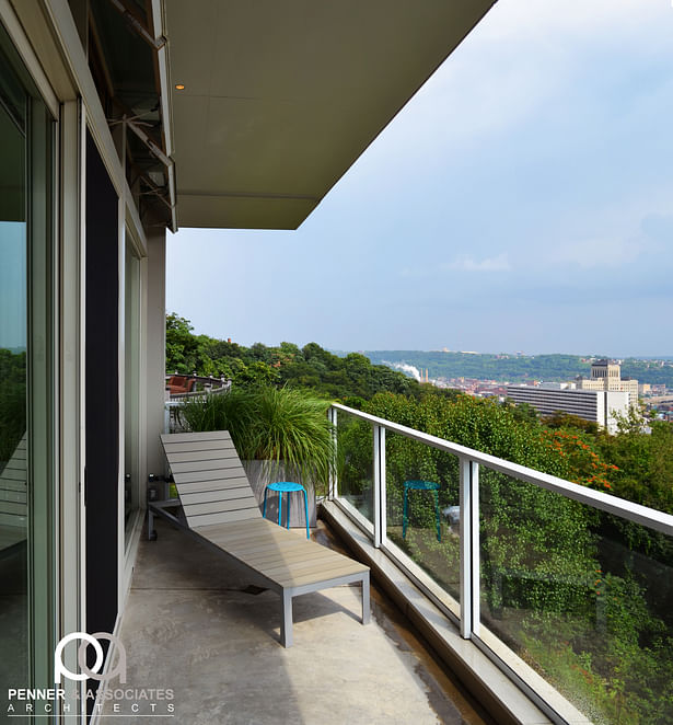 The balcony has glass guards to ensure that the one-in-a-million view is never blocked, even when sitting. The floor above overhangs to provide cover and block harsh summer sun, while allowing low winter warmth.