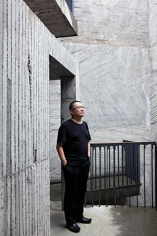  Architect Wang Shu at the Xiangshan campus of the China Academy of Art. The walls bear the imprint of the bamboo forms into which the concrete was poured. Photography by Zeng Han