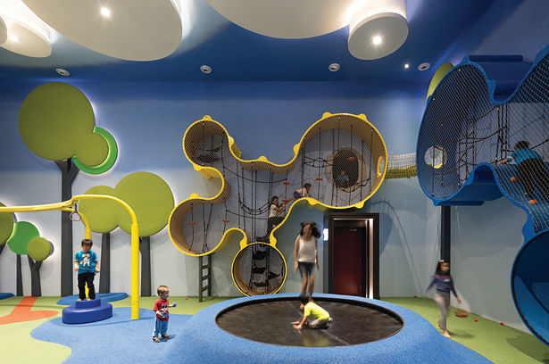 The Wall-o-lla play structure with tube slide connection to the screening area with regular entrance door below. 
