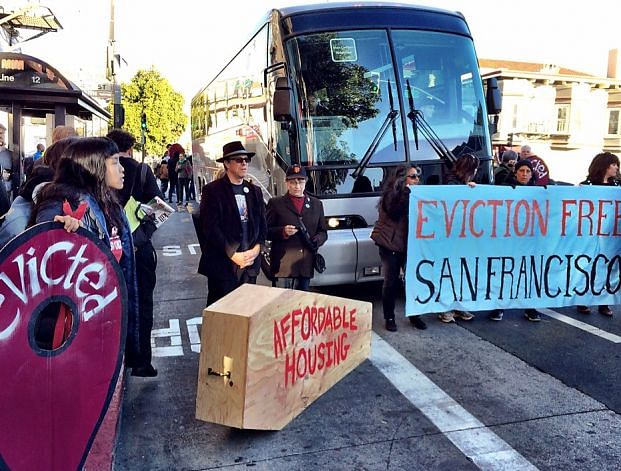 Protestors in front of a tech shuttle bus in San Francisco, 2013. Image via SFGate.