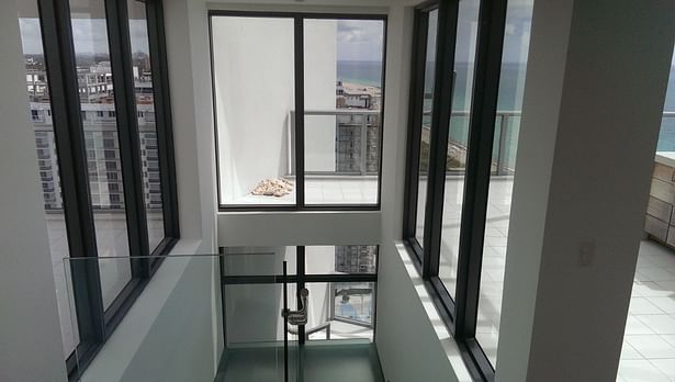 An additional glass window was installed to allow a view of both upper roof decks.