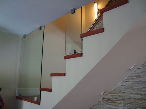 Glass Panel Railing's anchored with Squared Stainless Steel Brackets.