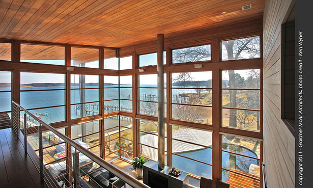 View from the upper level bedrooms, overlooking the living room and its fabulous water vista.