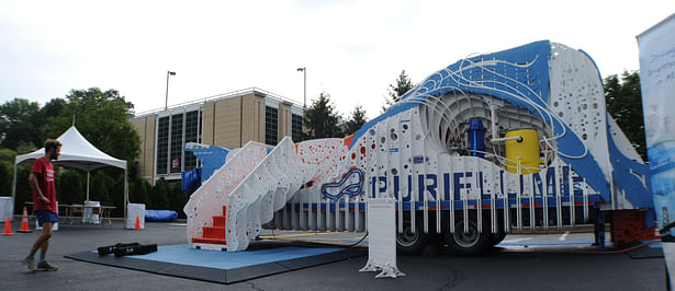 Exit side elevation view of the PURIFLUME in operation. From left to right : the exit stairs, educational track, visual systems void, and the slide entrance.