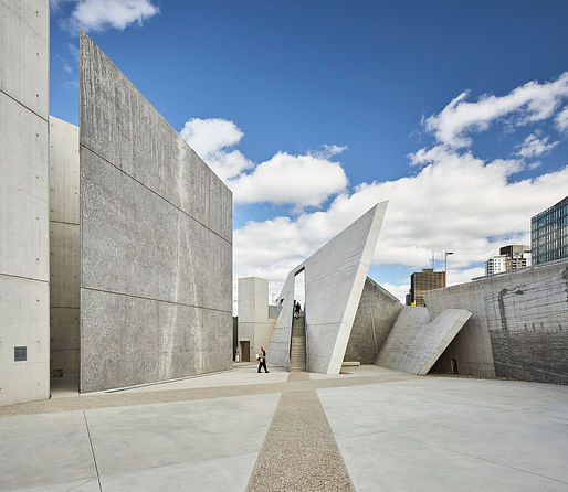 This interior view of the central space shows the application of Edward Burtynsky’s large-scale, monochromatic photographic impressions of Holocaust sites, painted in great detail on the towering concrete walls.