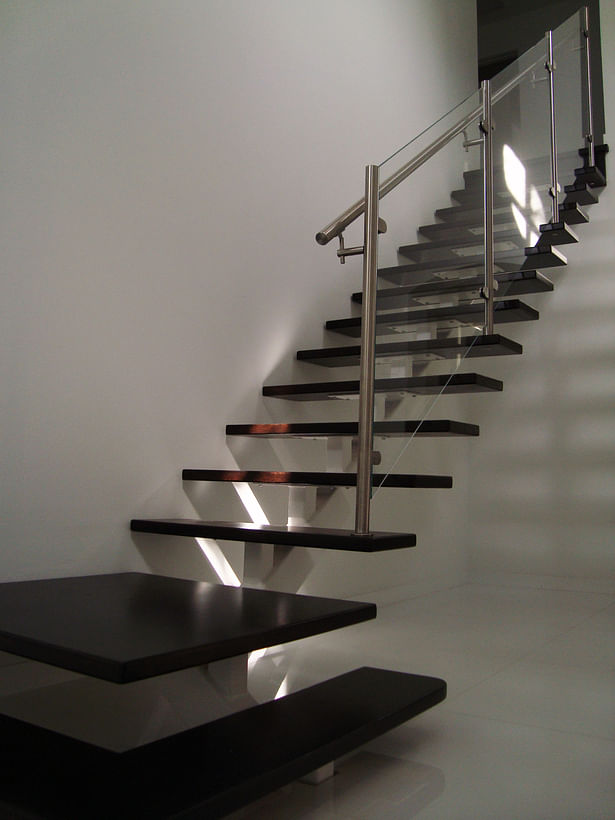 Chic Center-beam Staircase Featuring Open Riser Wood Treads with Glass & Stainless Steel Elements