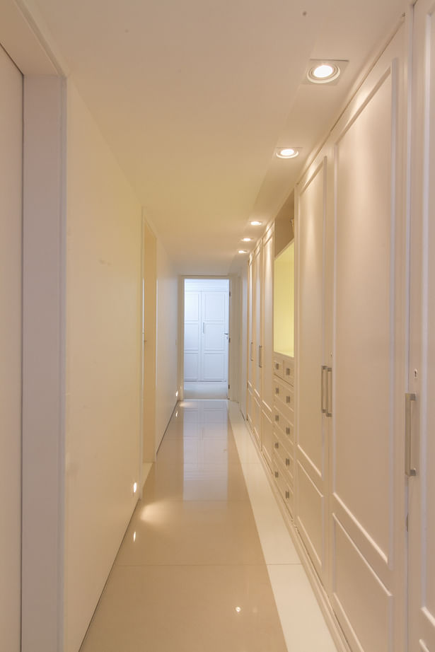 corridor towards bedrooms with restored recessed cabinets at right