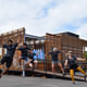 Team members from California Polytechnic State University, San Luis Obispo, kick up their heels during a team cheer at the U.S. Department of Energy Solar Decathlon at the Orange County Great Park, Irvine, California, Monday, Oct. 12, 2015. (Credit: Richard King/U.S. Department of Energy Solar Decathlon)