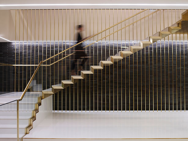 The striking brass staircase guides people from different umbrella companies up to their dedicated floors