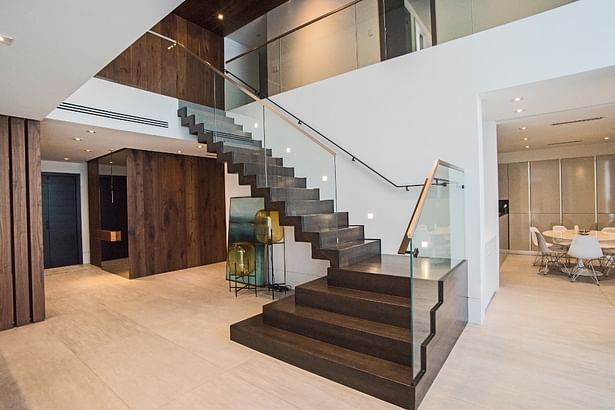 Stainless steel cap rails & handrails were added to this grande contemporary staircase, tying in perfectly with the homeowner's style and decor.