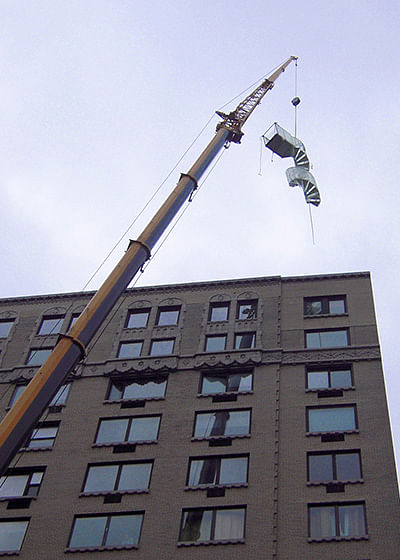 Crane Lifting Outdoor Spiral Staircase to Rooftop of Penthouse