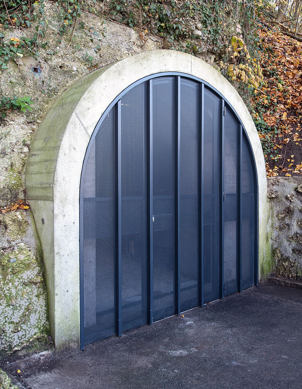 Gate 2: When closed the gates form translucent walls that close off the tunnel from the outside. There are no door handles or visible entry signs.