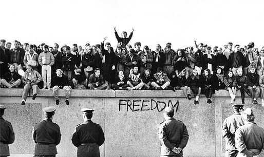 East German guards watch the crowds massing on top of the Berlin Wall in 1989. Photo: GDR Museum 