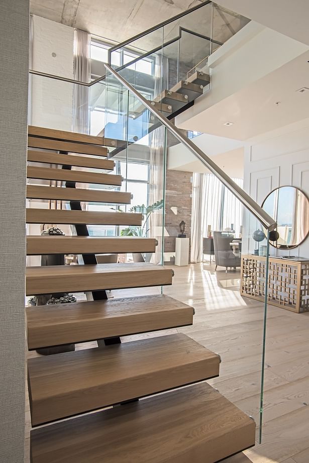 Matte Black Center Beam Staircase Featuring European Oak Treads and Glass Railings