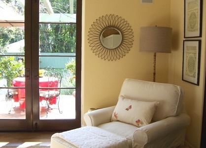 sunroom reading corner with view to exterior pergola