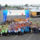  The competing teams pose for a group shot on opening day of the U.S. Department of Energy Solar Decathlon. (Credit: Thomas Kelsey/U.S. Department of Energy Solar Decathlon)