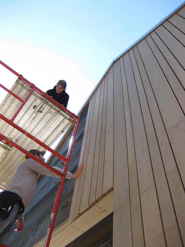 Students completing siding