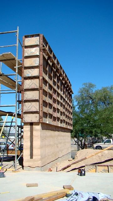 removing layers of formwork from rammed earth
