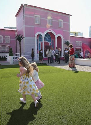 Visitors wait to enter the Barbie Dreamhouse Experience on May 16, 2013 in Berlin, Germany. [Sean Gallup/Getty Images]