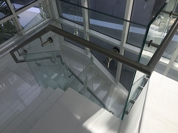a stainless steel handrail was directly mounted to the glass panels.