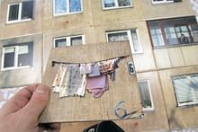 Lithuanian design studio Gyva Grafika transforms bathroom tiles into apartment block windows