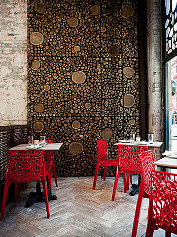 Whimsical chairs and window panels are reminiscent of urban Barcelona