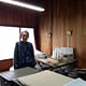 Yanai San standing in his home office