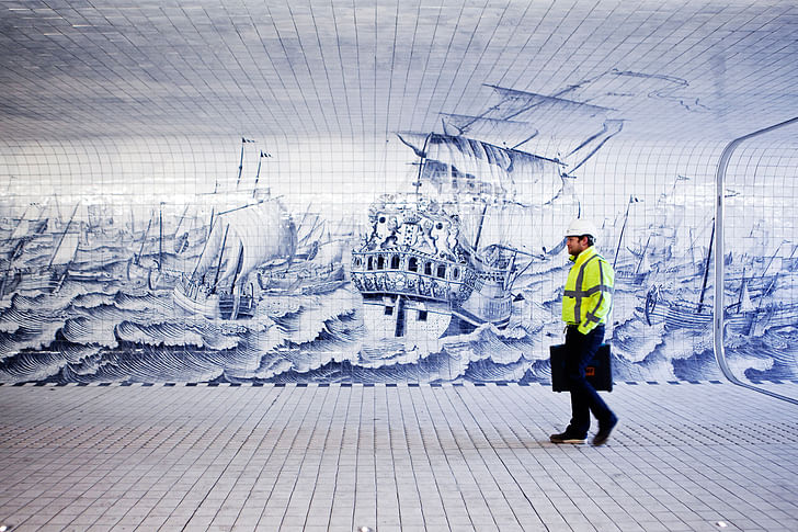 A pedestrian walks next to a detailed tableau inpired by the work of Cornelis Boumeester and designed by Irma Boom Office