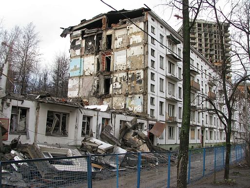 A half-demolished 'Khrushchyovka' apartment block in Moscow with new development behind. Image: Wikipedia.