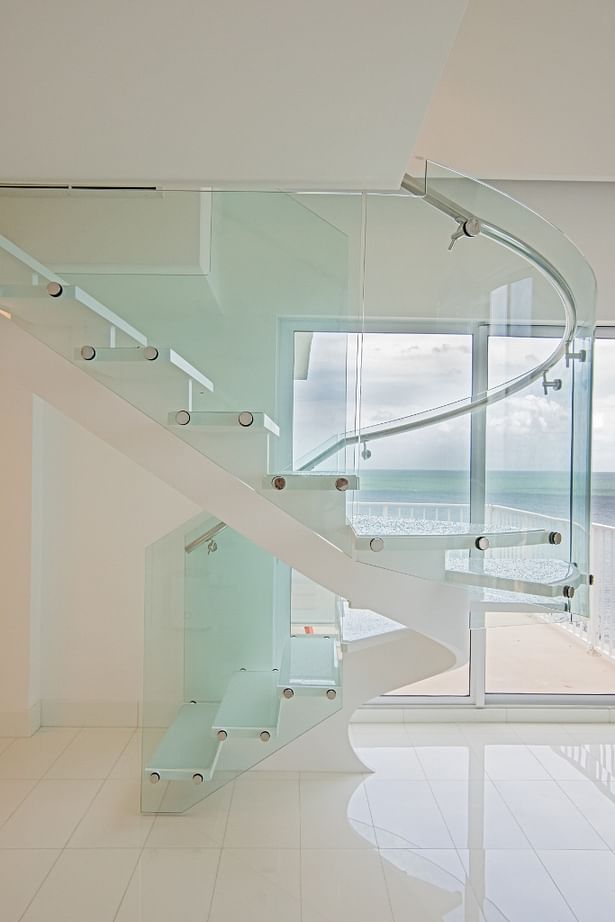 Curved Glass Railings were added to allow natural light in without obstructing those beautiful ocean views.