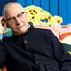 European Prize for Architecture laureate Alessandro Mendini sitting on a Proust Armchair, one of his many iconic designs.