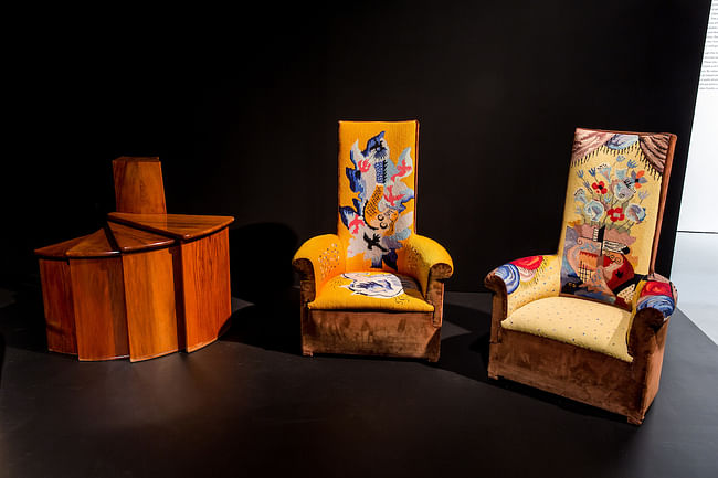 Left to right: Pierre Chareau, telephone fan table, c. 1924, wood. Private collection, New York; Pierre Chareau, Two high-backed chauffeuses (fireside armchairs), c. 1925, wood and velours, with tapestry upholstery by Jean Lurçat, reupholstered 1968. Private collection. Photo: Will Ragozzino/SocialShutterbug.com. Exhibition design by Diller Scofidio + Renfro.