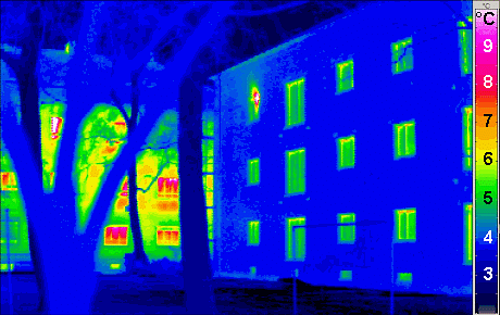 A thermogram of a passive house (right) shows how little heat escapes compared to a regular building. Credit: Wikipedia
