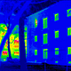 A thermogram of a passive house (right) shows how little heat escapes compared to a regular building. Credit: Wikipedia
