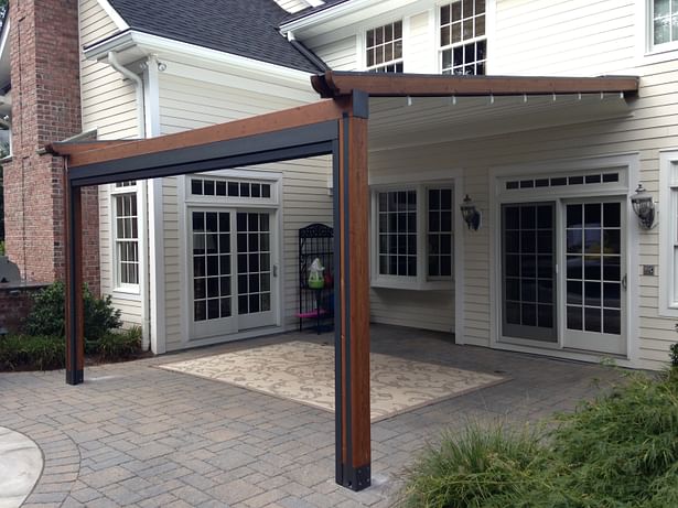 The Gennius Pergola Awning with cover projected, and solar shade retracted