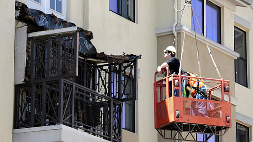 Engineers from Balfor Construction Co. examine what remains of a balcony at the 177-unit Library Gardens complex near UC Berkeley. Six people, all from Ireland, were killed when the balcony collapsed early in the morning. Image credit Mark Boster / LA Times.