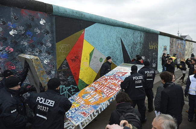 Police removed a piece of fake concrete used by protesters to fill out a gap during the removal of a section of the East Side Gallery. (image via spiegel.de)