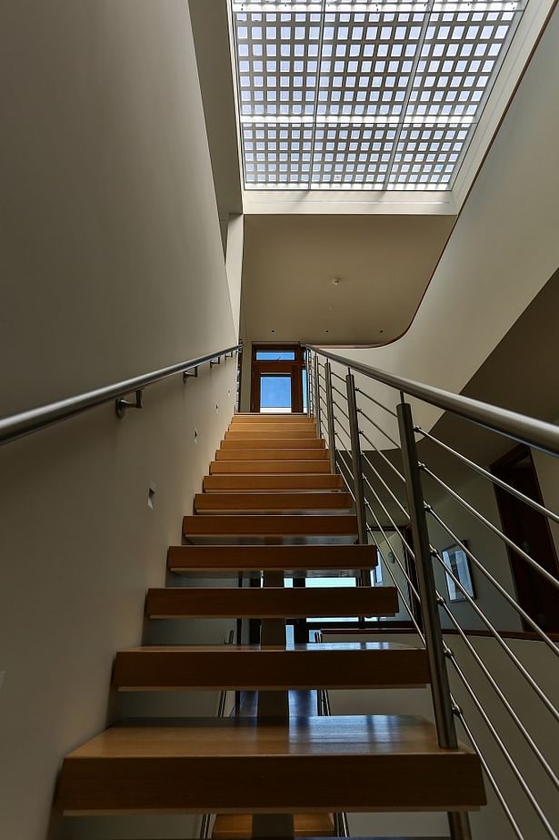 Stainless Steel Rod Railings were installed on this Center Beam Staircase.