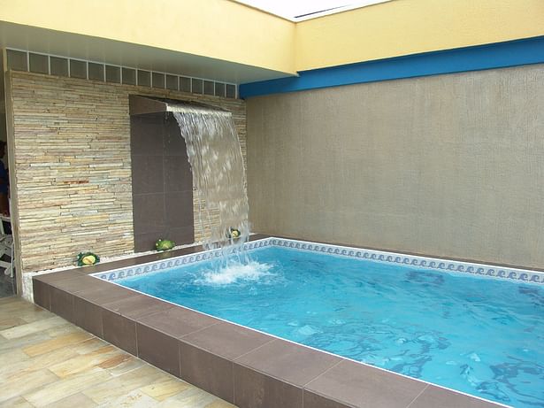 Pool cascade, combination of porcelain tile and natural stone.