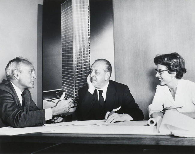 Philip. Johnson, Ludwig Mies van der Rohe, and Phyllis Lambert in front of an image of the model for the Seagram building, New York, 1955. (Photographer unknown. Fonds Phyllis Lambert, Canadian Centre for Architecture, Montreal. © United Press International)