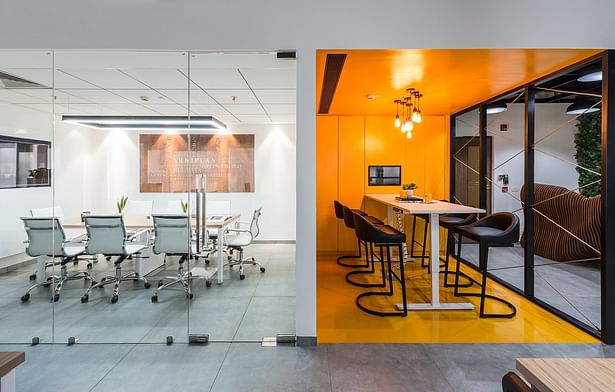 Both the meeting rooms with their distinct language and elements present a dynamic chemistry of contrasting variables.