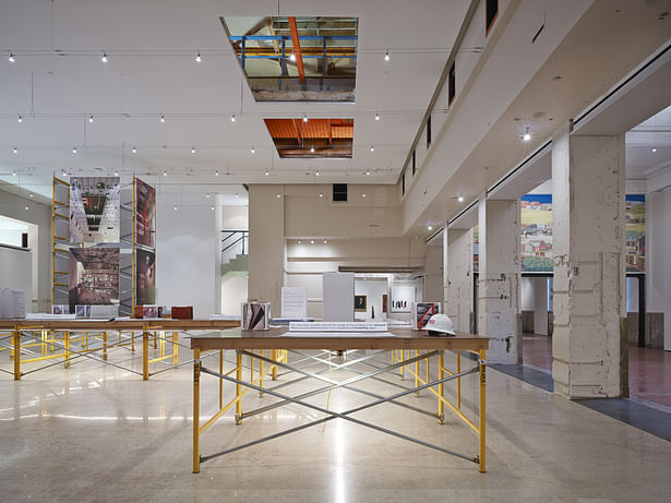 What was once the postal sorting room is now the main gallery space. The overhead catwalk and windows remain in place where postal security once watched the postal sorting process. Cable lighting spans the space and the lights float in the volume. 