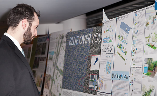 Attendee looks at project display boards during Infill Philadelphia: Soak It Up Design Awards event held March 7, 2013 at the Academy of Natural Sciences of Drexel University © CG Lawrence Photography (Gregory Clarke)