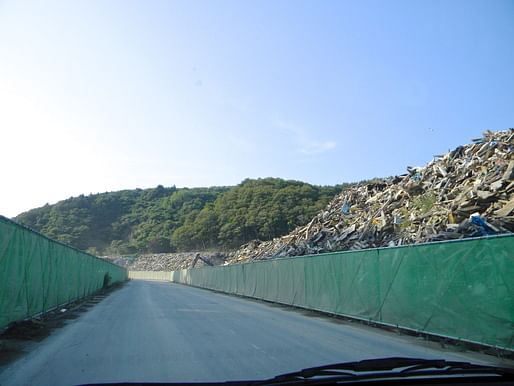 Piles of Debris on our way to Onagawa Temporary Housing about atleast 2 kilometers at an average of 25' high.... Literally a sh*t ton of trash with nowhere to go..for now I hope. via John Tubles